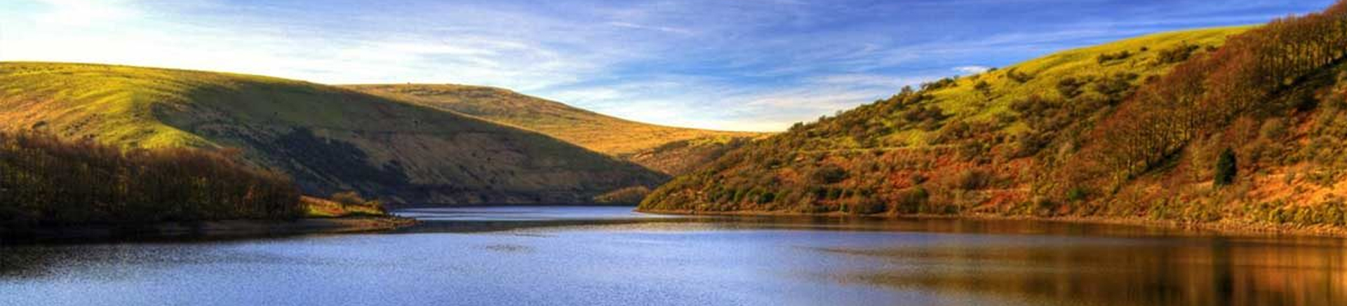 beautiful meldon reservoir, moorland in autumnal colours with flat reflective water