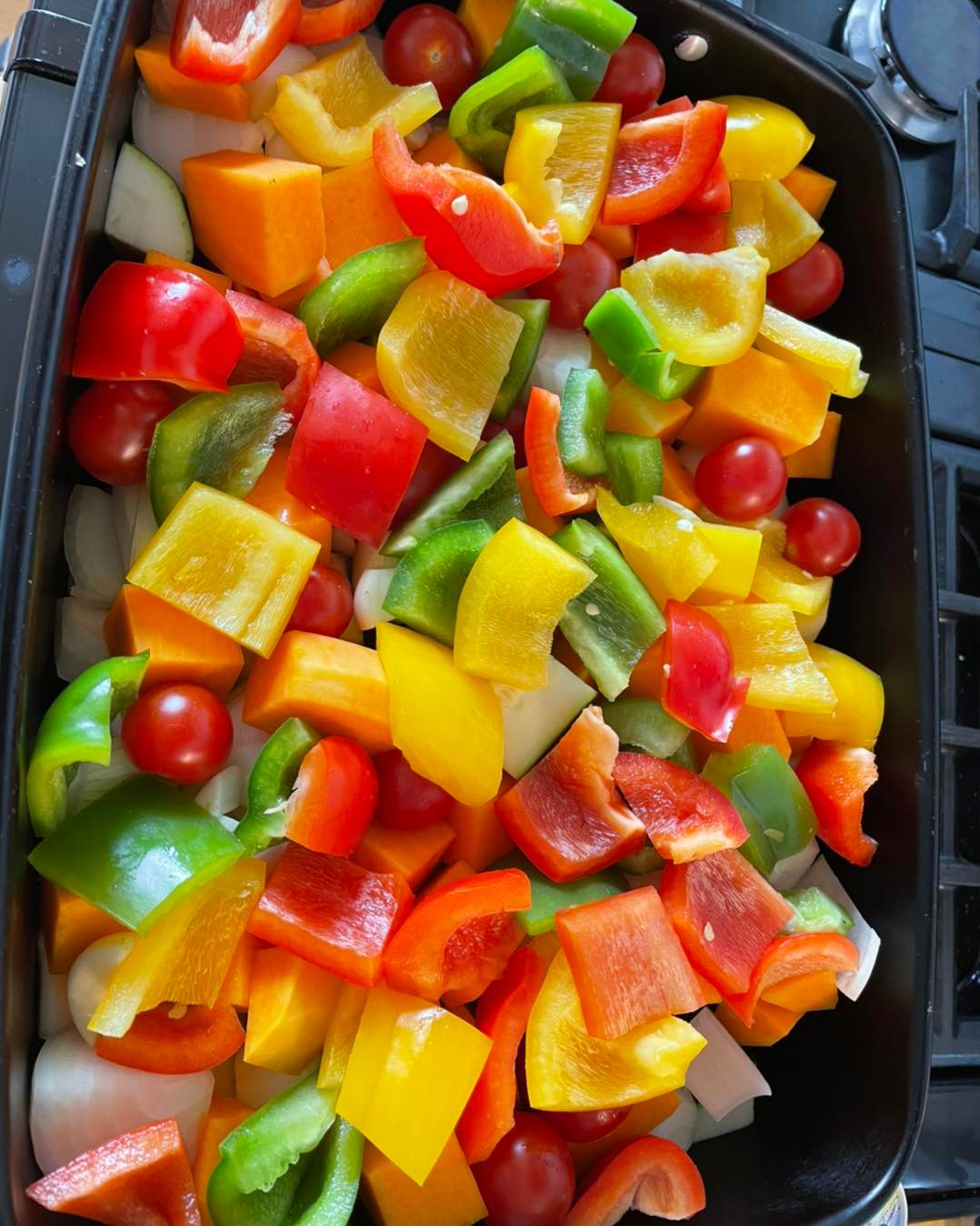 brightly coloured freshly cut vegetables, onions, peppers and tomatoes