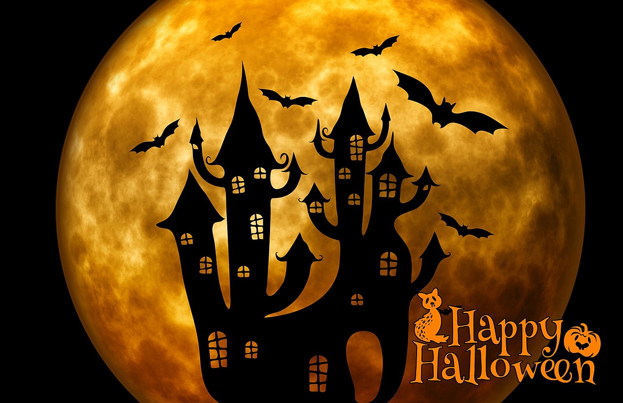 Shadow of a spooky house against the backdrop of a large moon with bats flying around and the caption happy halloween