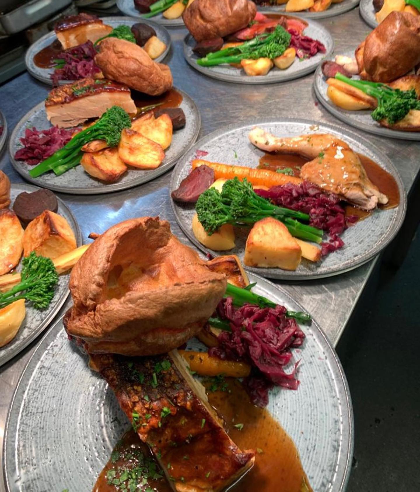 A number of plates with roast dinner on them
